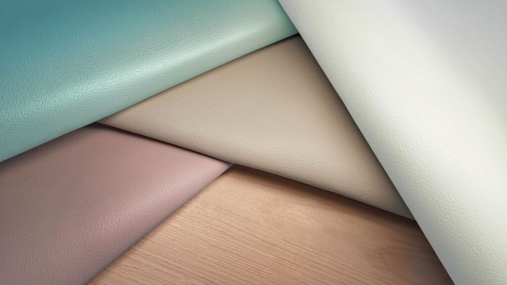 A collection of vibrant fabric swatches showing texture and color variety, arranged artistically.